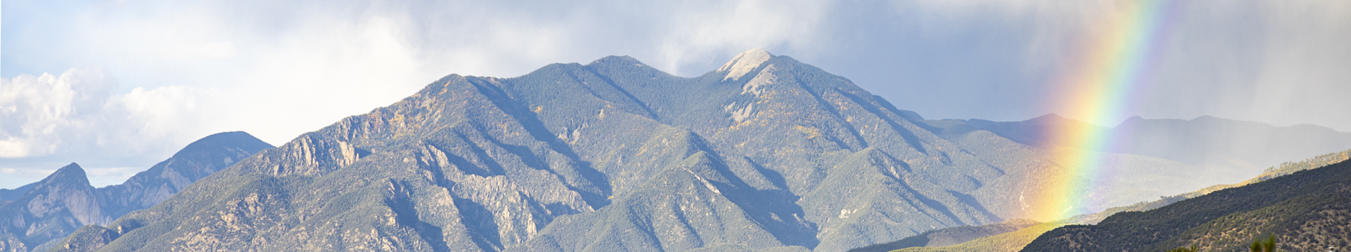Scenic mountain landscape with a vibrant rainbow, symbolizing hope and wellness in Primary Care.