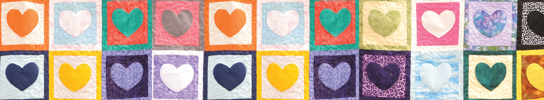 Colorful quilt squares featuring various heart designs, symbolizing love and support for cancer patients.
