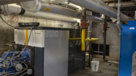 Industrial boiler system with pipes and valves, showcasing components of the Trane Energy Saving Project.