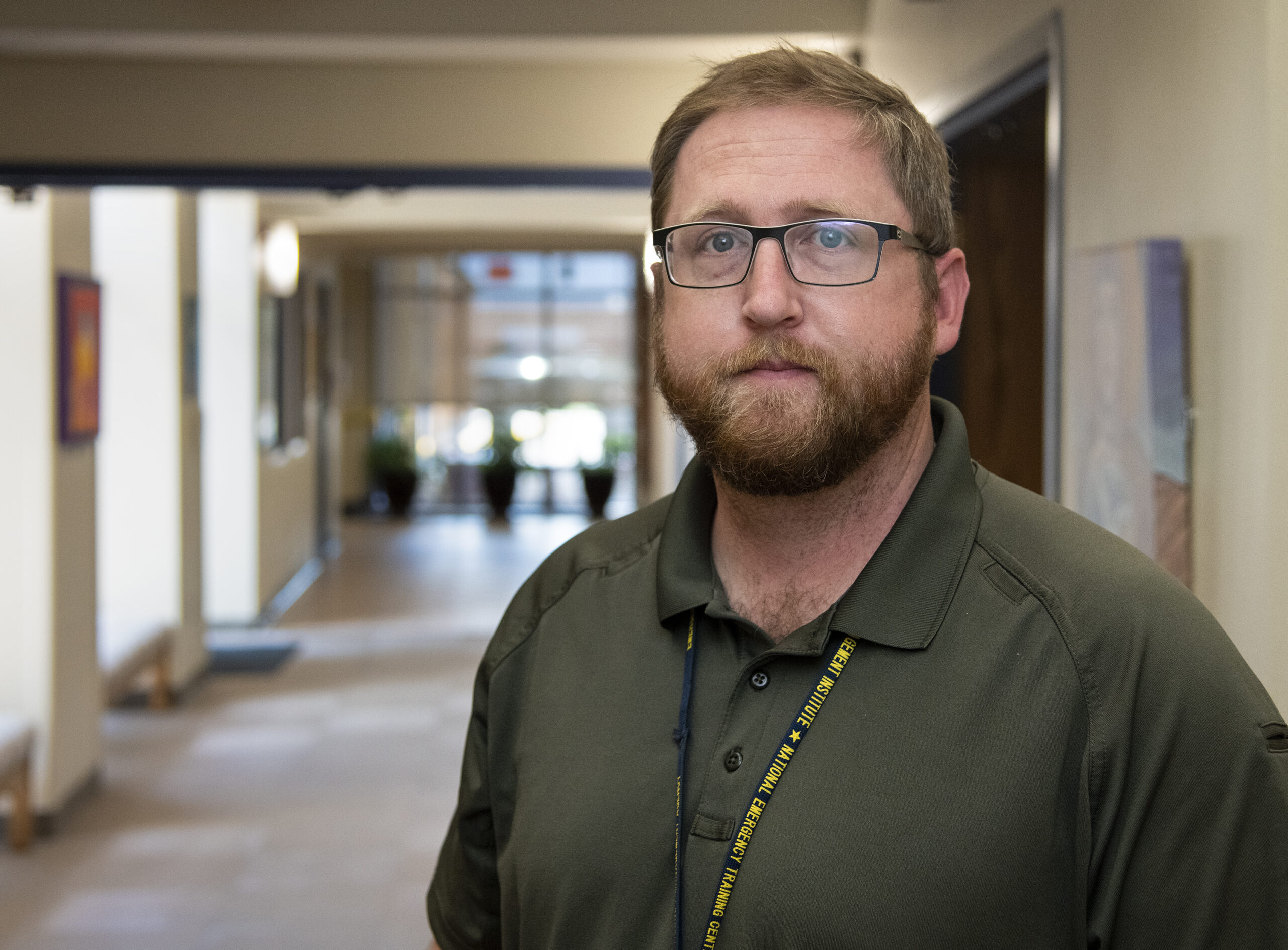 David Elliot stands in a hallway, representing his new role as a National Healthcare Disaster Professional.