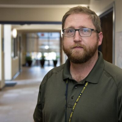 David Elliot, the 2021 Citizen of the Year, poses in a hallway, showcasing his dedication and community spirit.