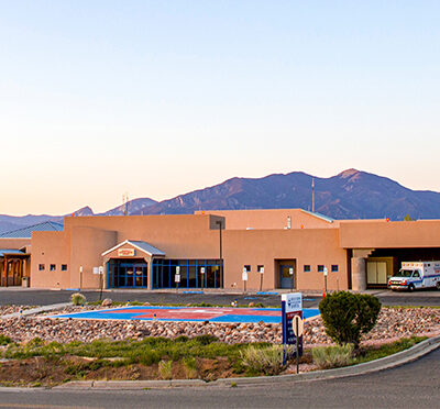 Health care facility surrounded by mountains, highlighting gratitude for medical staff and community support.