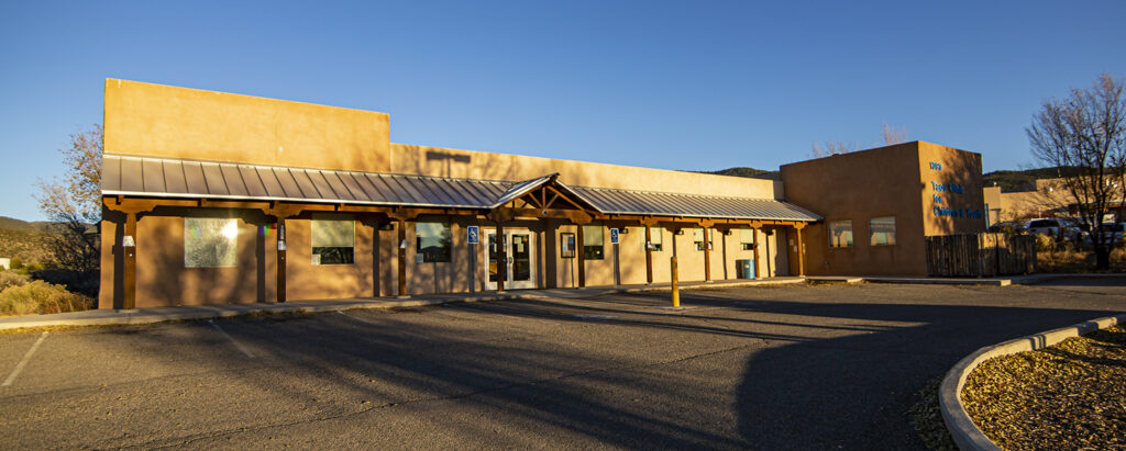 Pediatric clinic building with a welcoming entrance, designed for children's healthcare in Taos, New Mexico.