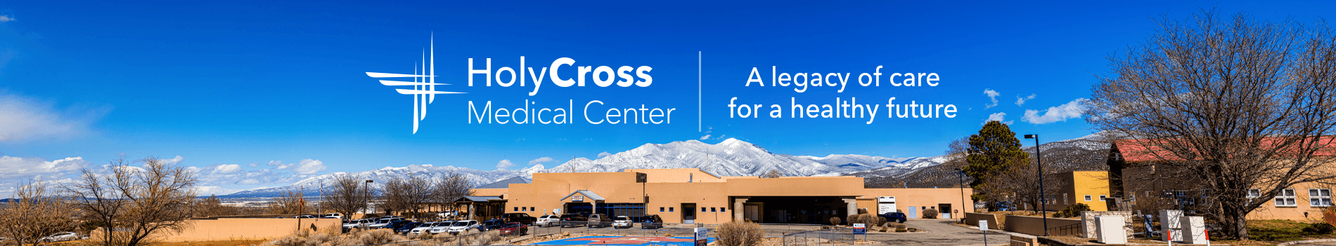 Holy Cross Medical Center building with a clear sky, promoting donations for a legacy of healthcare.